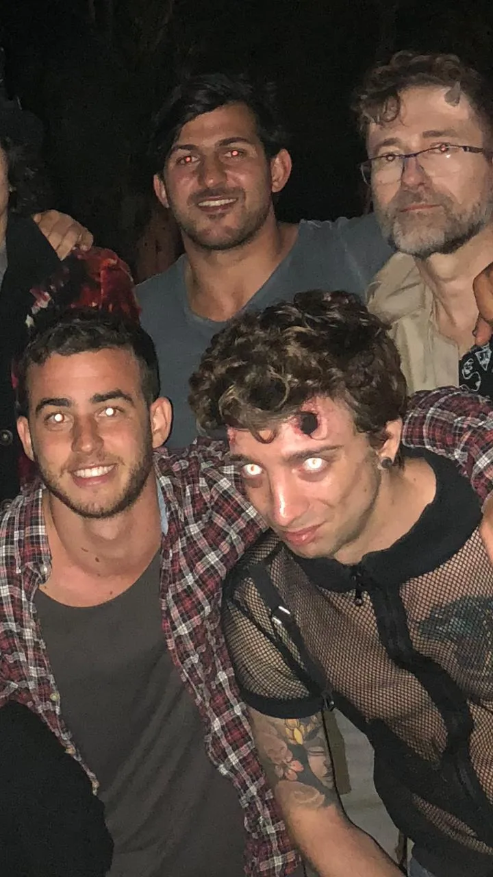 Cuatro amigos en una fiesta de disfraces, con flash directo